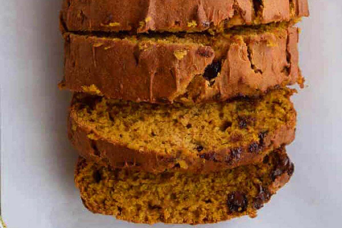 A slice of pumpkin bread on a white plate.