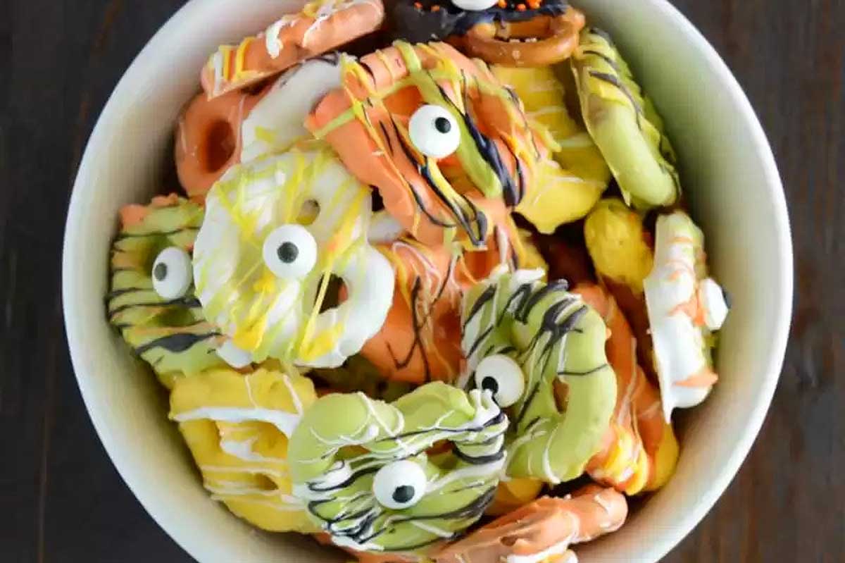 a bowl of Pretzel Treats with candy eyes on them.
