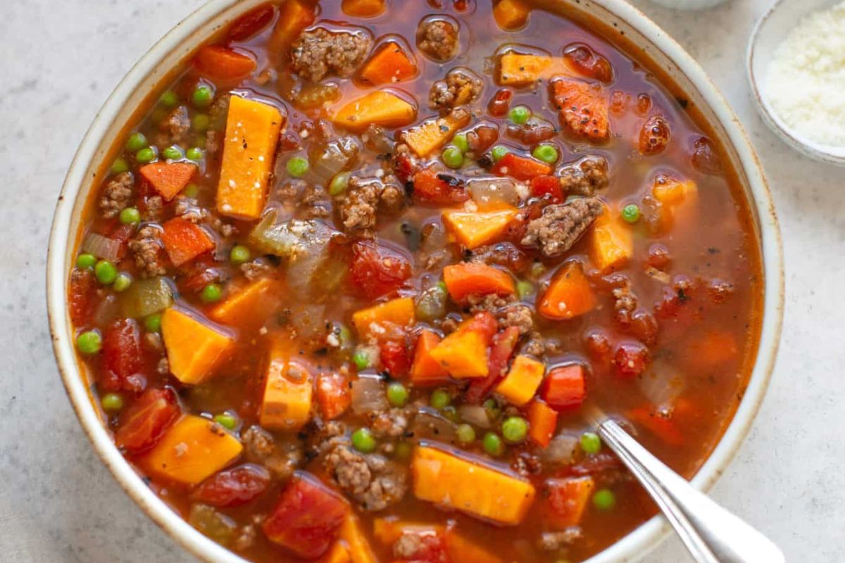 hamburger soup in a bowl with a spoon.