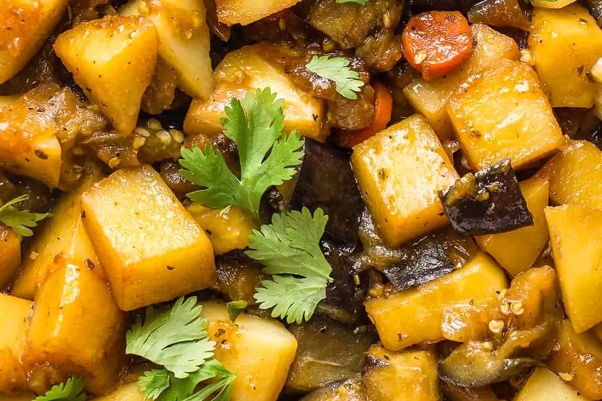 Eggplant stew garnished with fresh herbs.