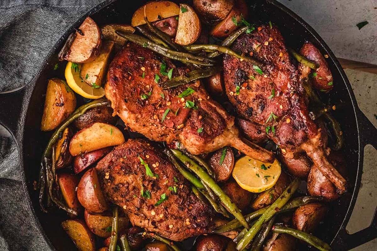 Honey garlic pork chops in a skillet.