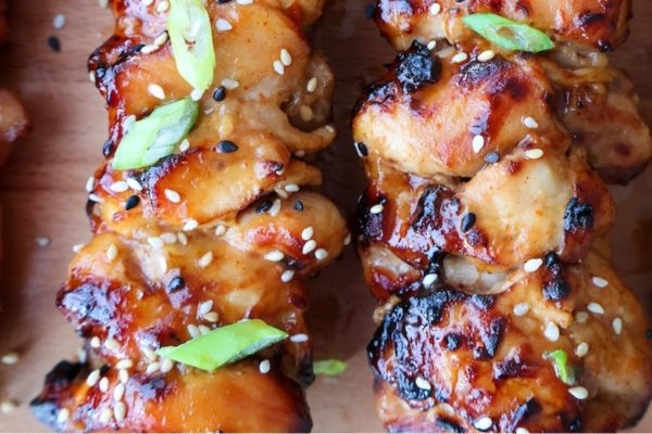 Honey garlic chicken skewers with fresh herbs.