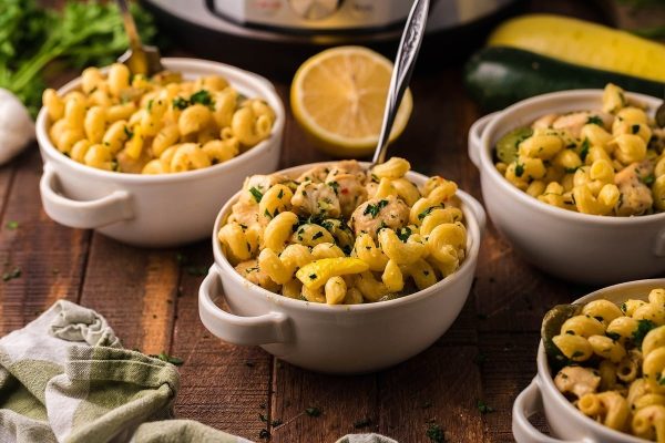 Buttery pasta in four bowls.