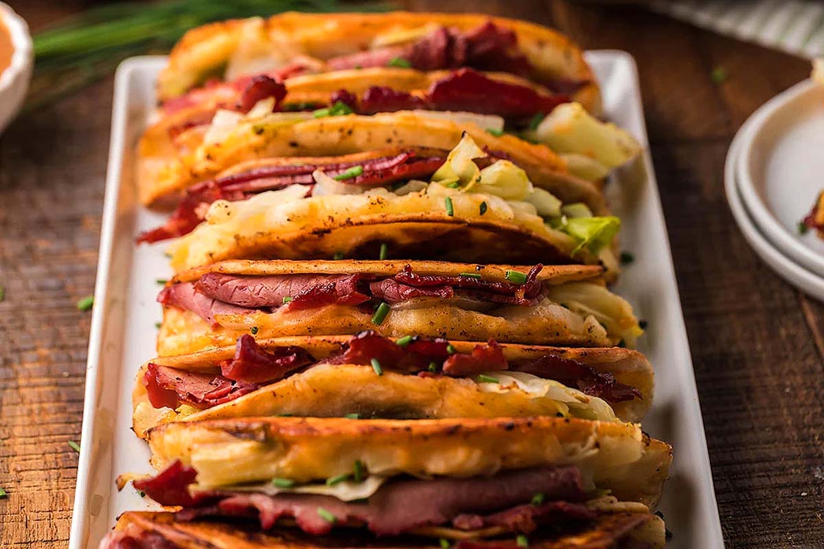 A plate with a stack of tacos on it.