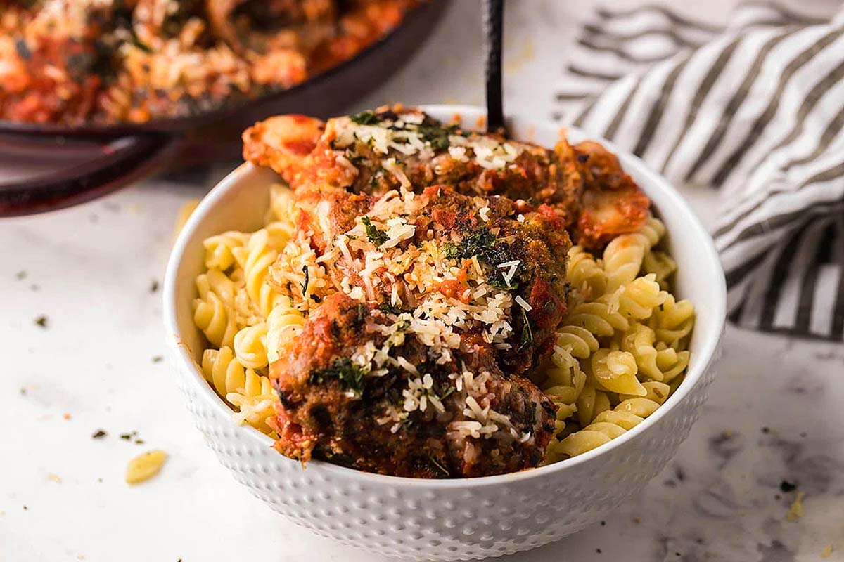 Beef rolls cooked in sauce and served over pasta.