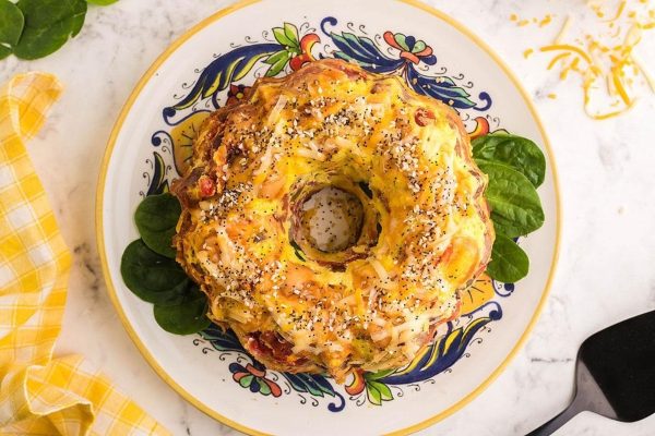 Loaded bagel breakfast on greens.