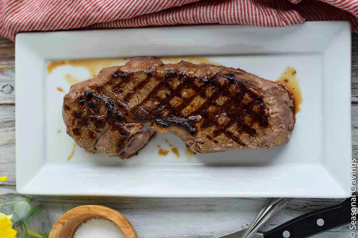 tender London broil on a white plate. 