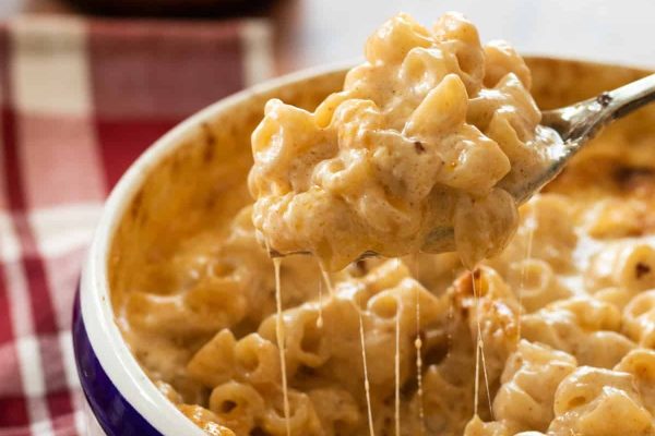 Mac and cheese with a scoop out.