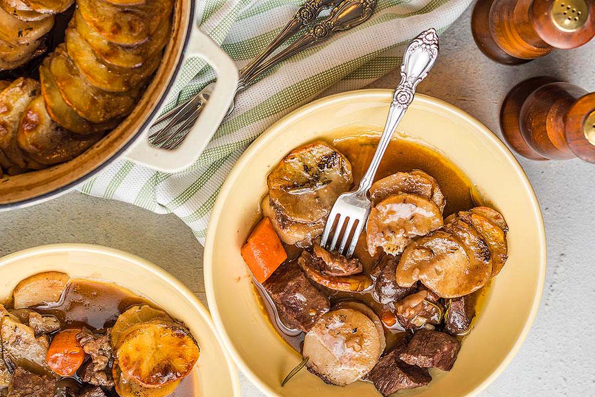 A meat and potato dish served in a bowl.