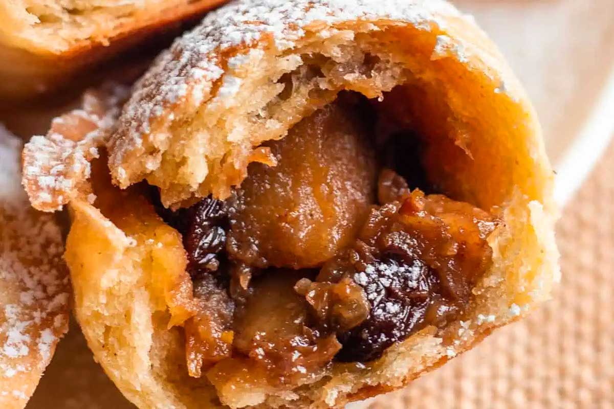 Apple hand pie cut open with apple filling showing.