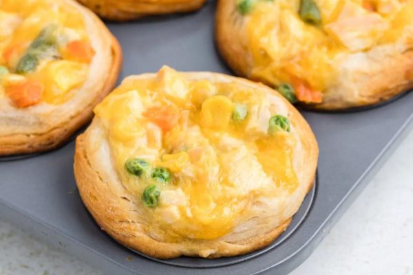Mini chicken pot pies in a muffin tin.