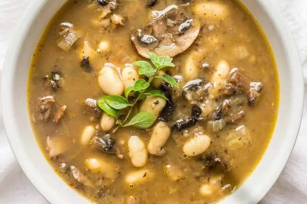 Mushroom bean soup in a white bowl.
