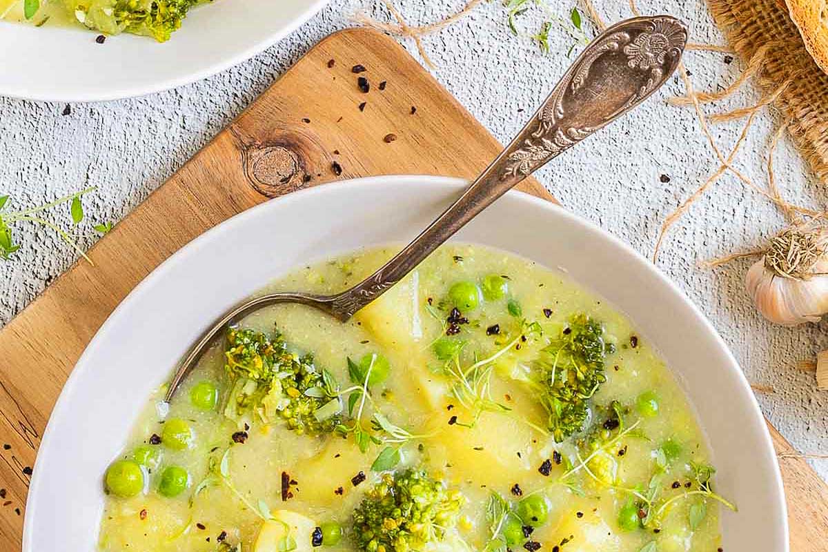 Potato and green vegetable stew in a serving dish.