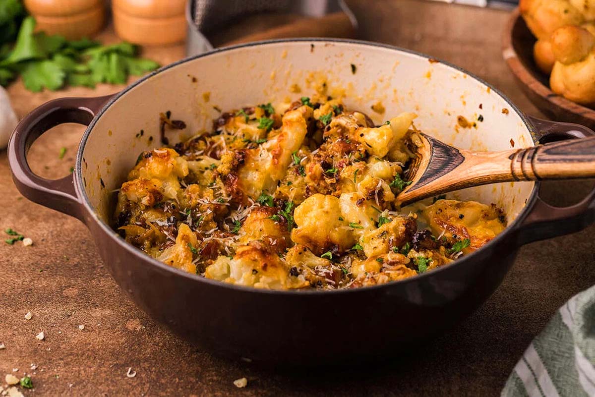 A cauliflower dish cooked with carbonara sauce and bacon.