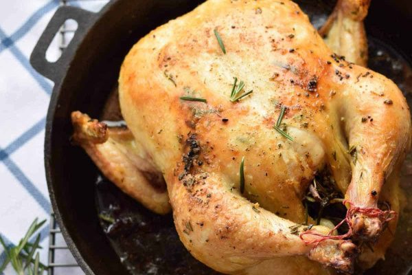 Rosemary roast chicken in a cast iron skillet.