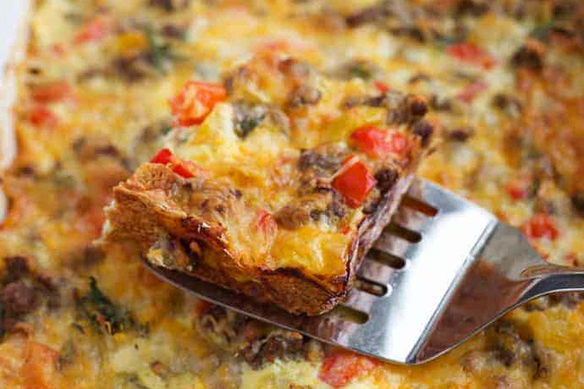 Slice of sausage and egg casserole on a spatula.