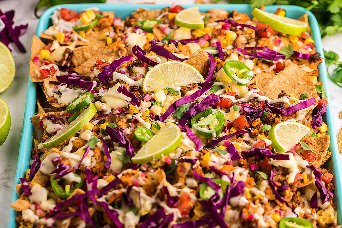 Mexican nachos in a blue baking dish.