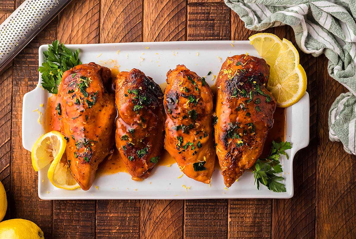 Chicken breasts on white tray.
