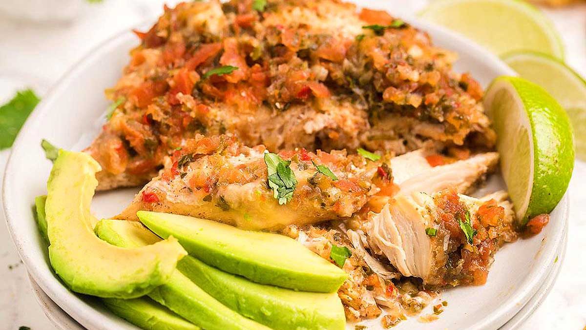 Salsa fresca chicken breast on a plate with avocado.