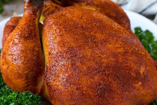 Whole smoked chicken with parsley.