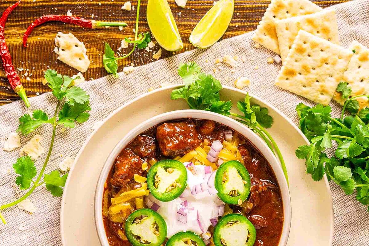 A bowl of smoked chili on a table.