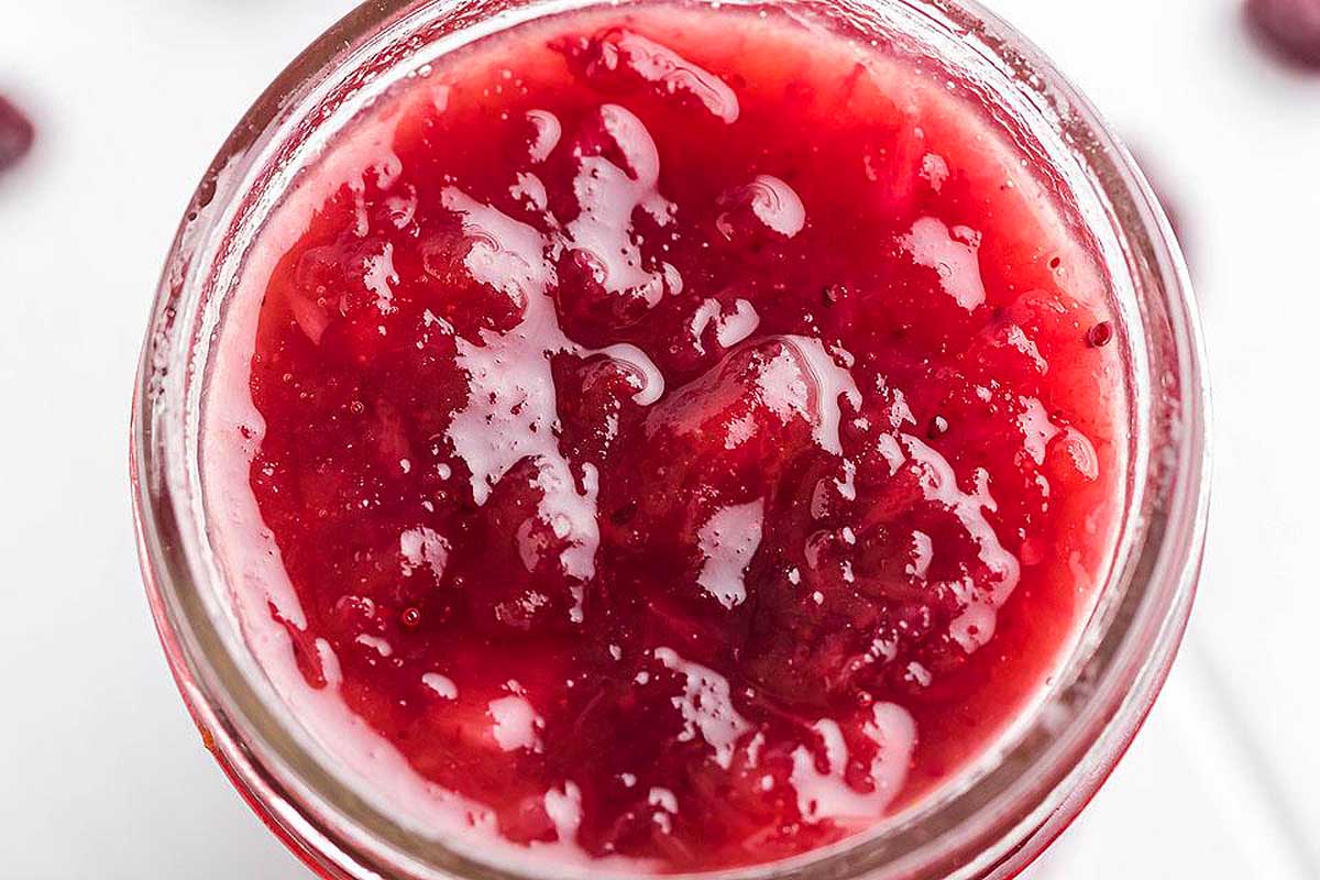 Spiked Pineapple Bourbon Cranberry Sauce in a glass cup.