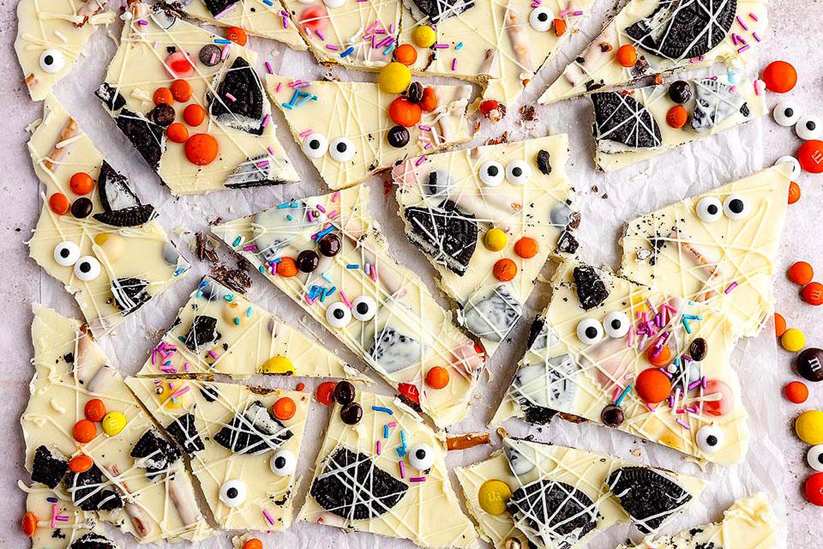 A white chocolate barn with oreo cookies and Halloween candy.