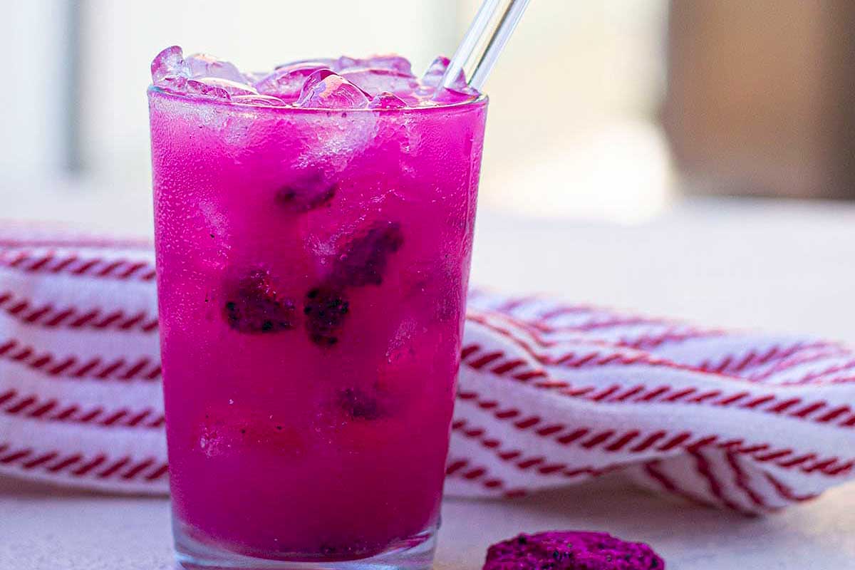 Mango and dragonfruit refresher drink in a glass.