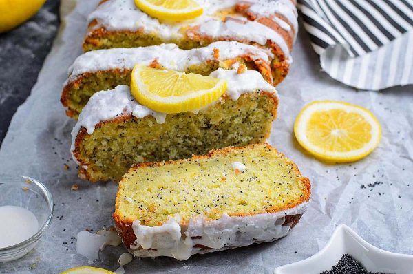 A loaf of lemon cake with lemon slices.