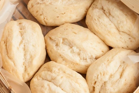 Several steamed buns in a basket.