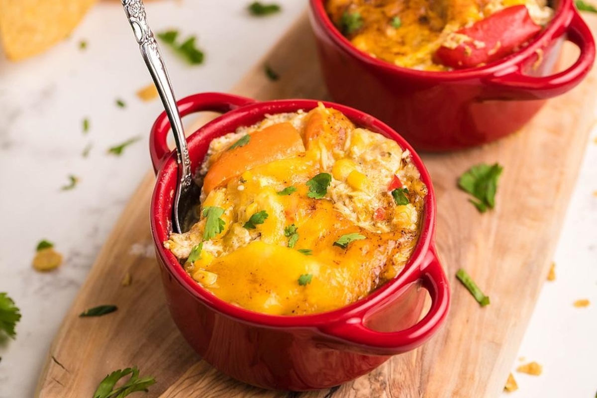 Enchilada casserole in two small red dishes.