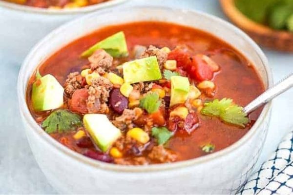 Taco soup in a white bowl.