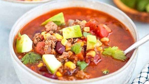 Taco soup in a white bowl.