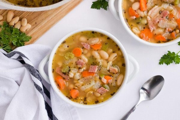 Two bowls of ham and cannellini bean soup.