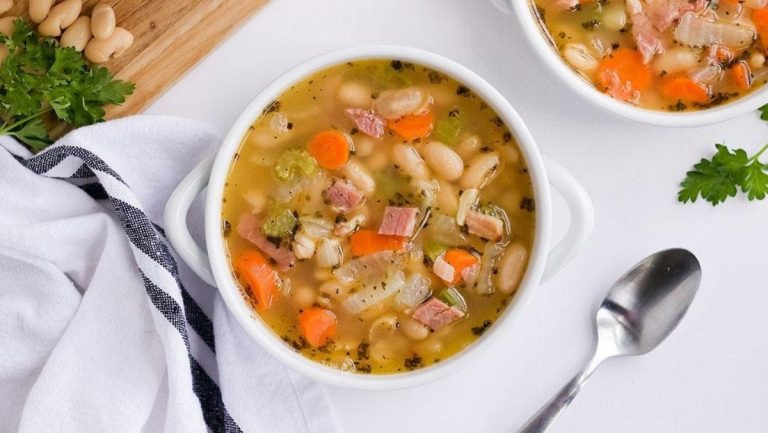 Two bowls of ham and cannellini bean soup.
