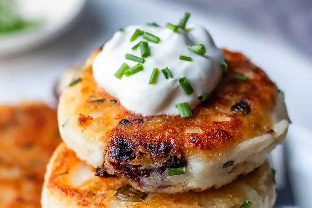 Golden brown potato pancakes topped with sour cream and chives.