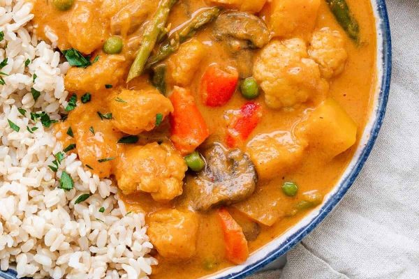 Butternut squash curry in a bowl with rice.