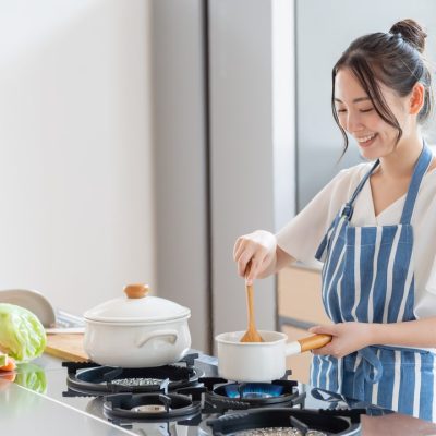 A woman cooking in a kitchen.