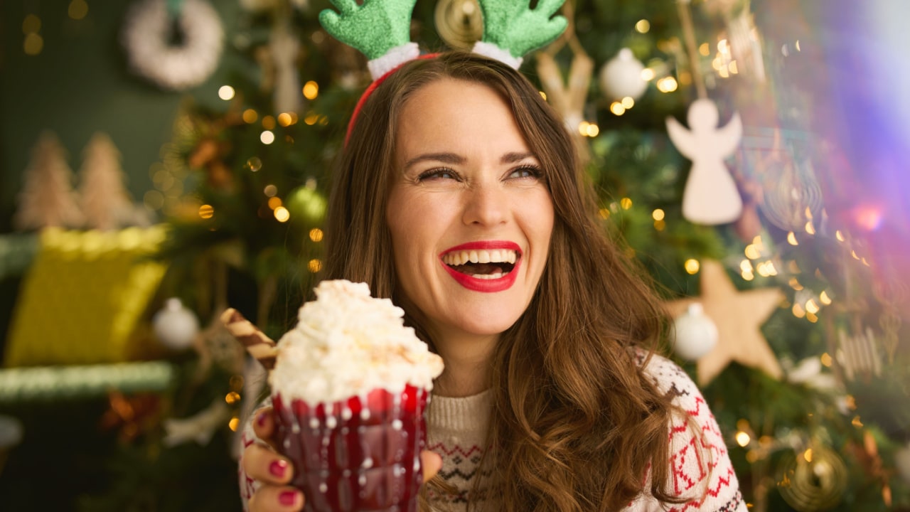 Woman drinking Christmas Cocktail at home.