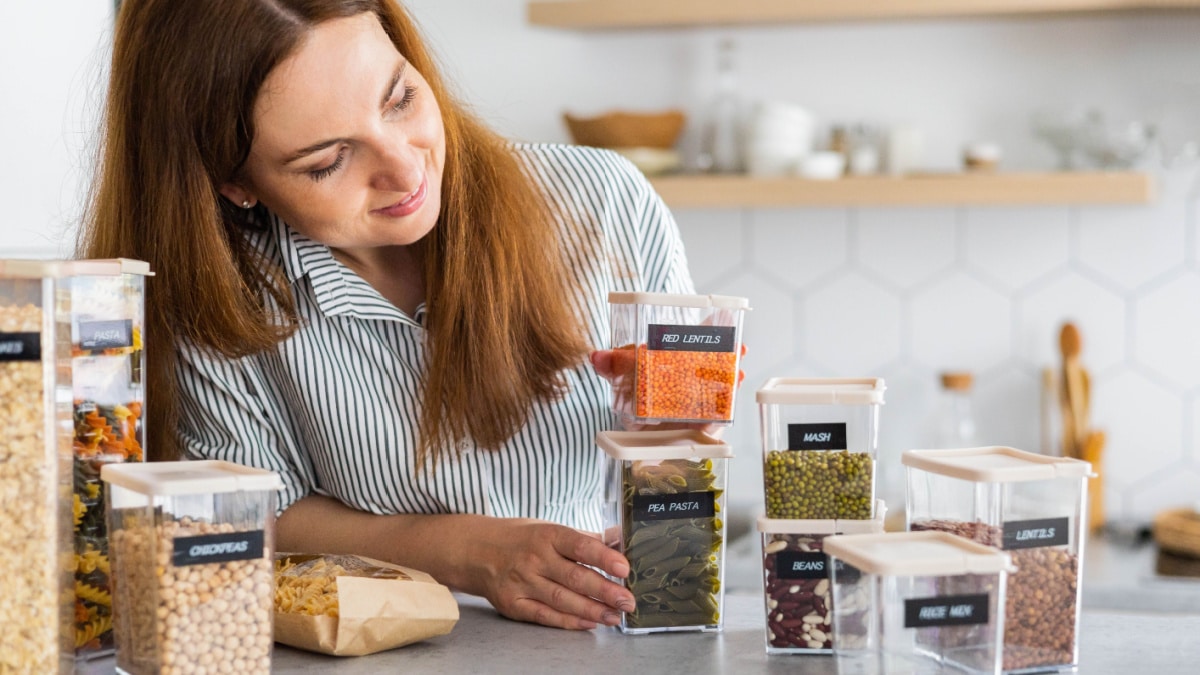 Woman organizing her kitchen storage.