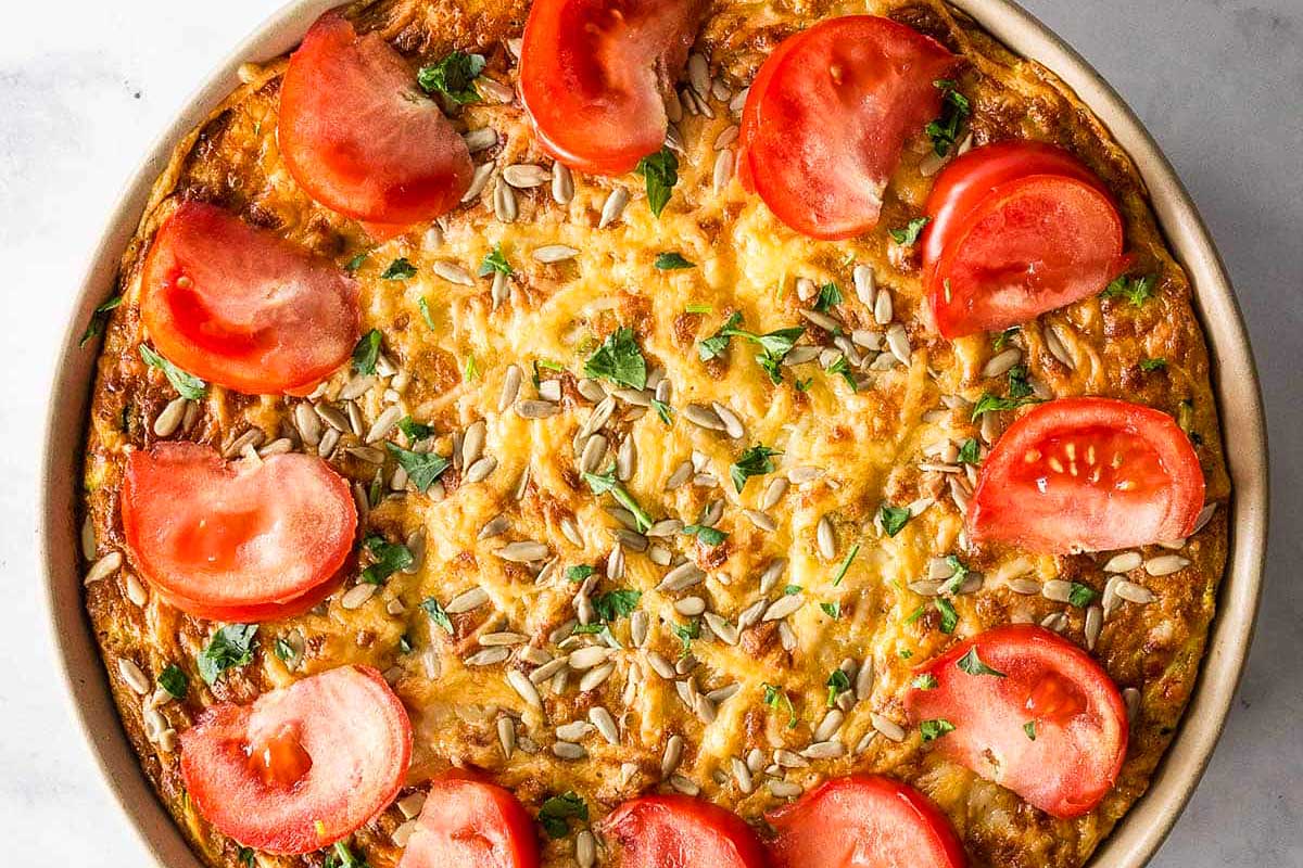 A zucchini and cheese quiche in a pan.