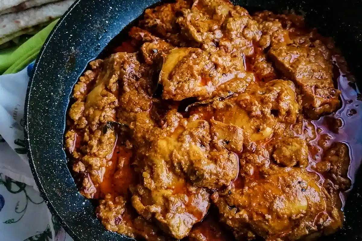 Chicken tikka masala in a skillet on a table.