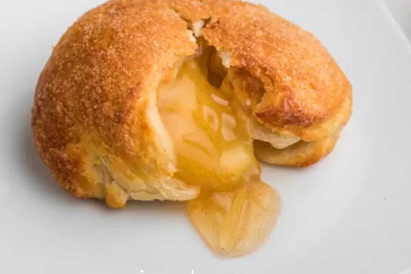 A pastry with a slice taken out of it.