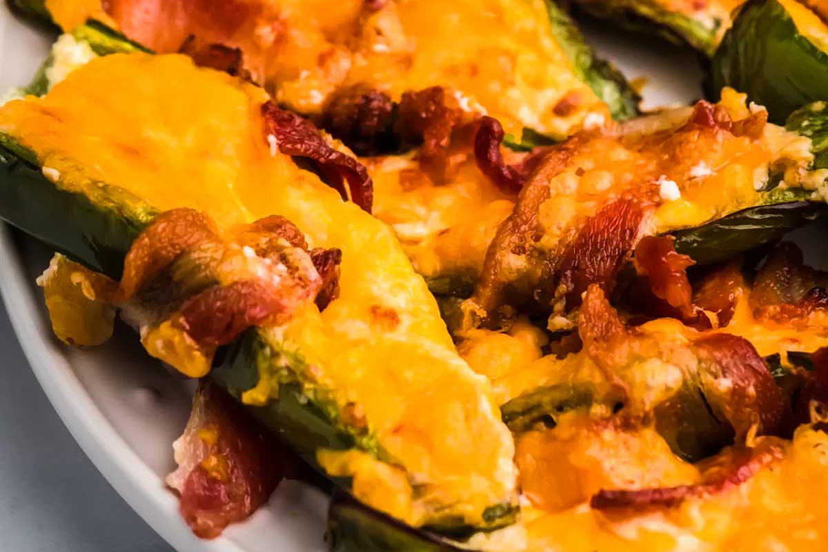 Stuffed jalapenos with bacon and cheese on a plate.