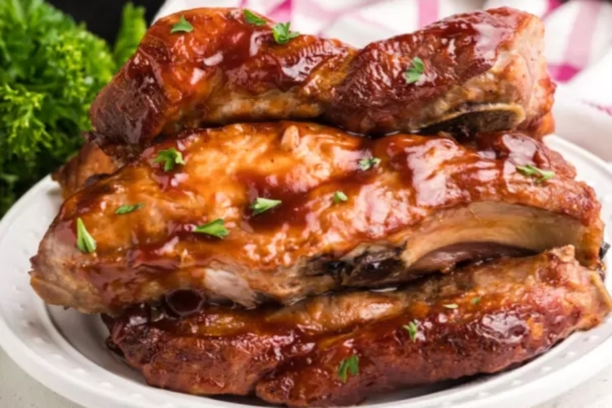 Thanksgiving Mains: Bbq ribs on a white plate.