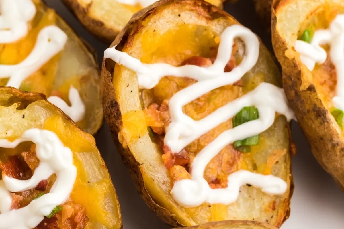 Cheesy potato wedges with bacon and sour cream.
