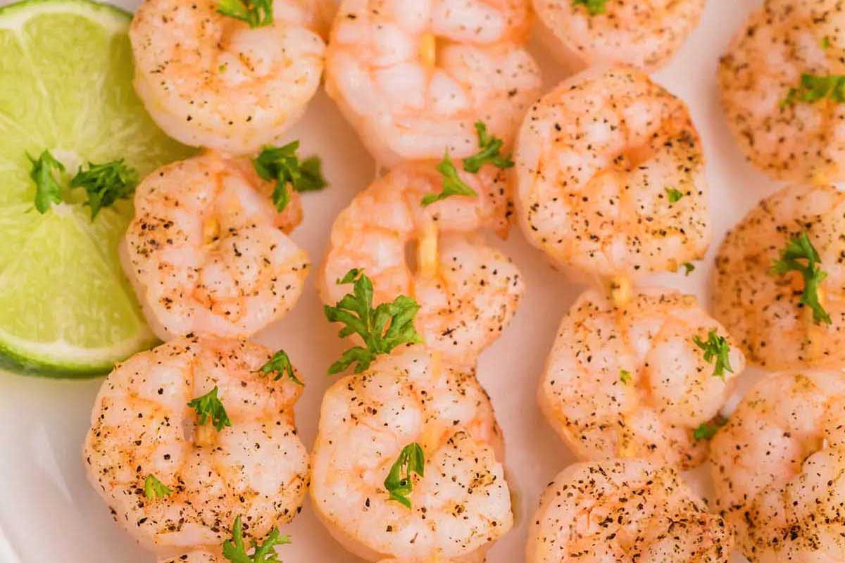 Shrimp skewers on a white plate.