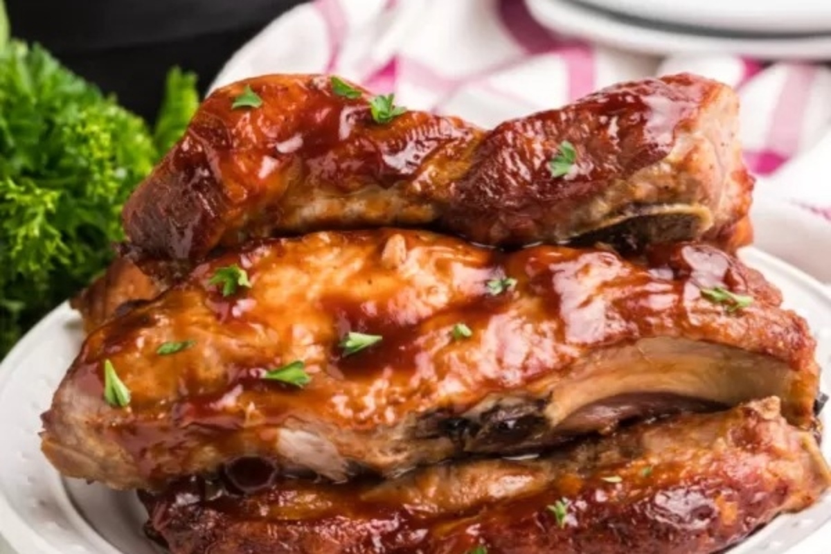 Bbq ribs on a white plate: This description showcases mouthwatering ribs, perfect for your next BBQ gathering.