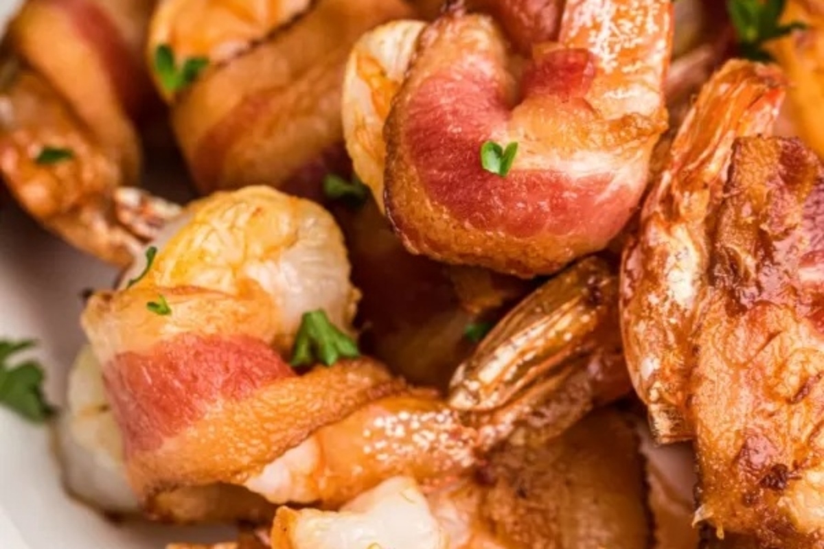 A delectable feast of bacon wrapped shrimp, elegantly presented on a plate.