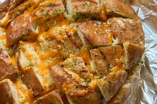 A cheesy bread covered in foil.